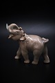 Royal 
Copenhagen 
porcelain 
figure of small 
elephant, 
design by Knud 
Kyhn. H:11cm. 
L:12cm. ...