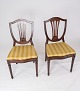 A set of dining 
room chairs of 
mahogany and 
upholstered 
with striped 
fabric from the 
1920s. The ...