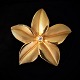 Bræmer-Jensen; 
A flower 
brooch, made of 
14k gold with a 
brillant-cut 
diamond, 
weighing 0.12 
ct. ...