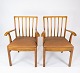 A set of two 
armchairs in 
light wood, 
upholstered 
with light 
brown leather, 
is a charming 
...