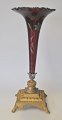 Ruby red 
trumpet glass 
vase with 
enamel floral 
decorations, 
approx. 1900. 
On square foot 
of ...