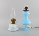 Antique 
petroleum 
burner and lamp 
in mouth-blown 
opal art glass. 
Approx. 1900.
The lamp ...