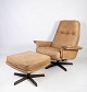An armchair and 
footstool, 
upholstered 
with light 
grain leather 
and with a 
frame in 
rosewood, of 
...