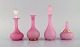 Two vases and 
two flacons in 
pink 
mouth-blown art 
glass decorated 
with 24 carat 
gold leaf. ...