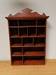 Red painted 
shelf with 14 
compartments 
Sweden about 
1900 1910Height 
69cm Width 44cm 
Depth 15cm.