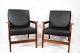 A pair of 
lounge chairs 
in polished 
wood and black 
classic leather 
of danish 
design from the 
...