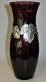 Large art 
nouveau vase in 
violet glass 
with pewter 
mounting, 
approx. 1920. 
Denmark. 
Optically ...