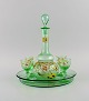 Legras, France. 
Cabarat Cigogne 
liqueur set in 
green 
mouth-blown art 
glass with 
hand-painted 
...