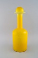 Otto Brauer for 
Holmegaard. 
Large vase / 
bottle in 
yellow art 
glass with 
yellow ball. 
...