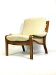 The armchair in 
rosewood, 
upholstered 
with light 
fabric and of 
Danish design 
from the 1960s, 
is ...