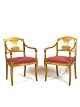 A pair of Late 
Empire birch 
armchairs, 
upholstered in 
red fabric and 
from around the 
1840s, make ...