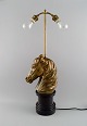 La Maison 
Charles, 
France. Large 
horse head 
table lamp in 
brass. Mid-20th 
century.
Measures: 60 
...