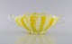 Murano bowl 
with handles in 
mouth-blown art 
glass. Wavy and 
checkered 
design in 
shades of 
yellow ...