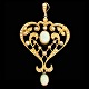 A pendant set 
with opals and 
pearls mounted 
in 14k gold. 
Around 1920. H. 
5,5 cm. W. 3,3 
...