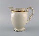 KPM, Berlin. 
Royal Ivory jug 
in 
cream-colored 
porcelain with 
gold 
decoration. 
1920s.
Measures: ...