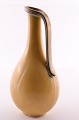 Large vase / 
jug in glazed 
stoneware. The 
glaze in shades 
of yellow with 
white and blue. 
From ...