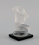 René Lalique, 
France. Nude 
woman in 
frosted art 
glass. Mid-20th 
century.
Measures: 8.5 
x 8 ...