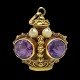 A pendant in 
18k gold set 
with amethysts 
and pearls. 
H. 3 cm. L. 
2,5 cm. W. 2 
cm. 
Please ...