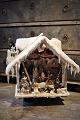 Decorative 
German 
Christmas house 
with many fine 
details, Snow 
on the roof 
with hanging 
icicles ...