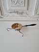 1800s tea 
strainer in 
silver with 
wooden handle. 
The tea 
strainer is 
gilded inside
Length 16 cm.
