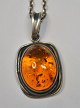 Amber pendant 
in sterling 
silver, 20th 
century. 
Stamped. With 
chain. Chain 
length: 50 cm.