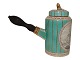 Royal 
Copenhagen 
Antique green 
coffee pot with 
wooden handle 
and decorated 
with putti.
This ...