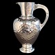 Grønlund; A 
pitcher made in 
hammered 
hallmarked 
silver. 
H. 22,5 cm. 
Grønlund, 
Denmark, 1903. 
...