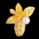 Jean Larsen; A 
pendant of 18k 
gold, leaves 
set with a 
pearl. 
H. 2,1 cm. W. 
1,8 cm.
Please ...