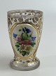 Bohemian 
drinking glass 
with gold leaf 
decoration and 
an enamel 
painted plaque 
with a bouquet 
of ...