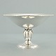 A silver center 
piece with 
circular foot. 
H. 8,5 cm. 
Diam. 13,5 cm.
Stamped with 
monogram
and ...