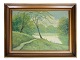 Painting on the 
canvas in a 
gold frame of a 
forest motif in 
green colors 
from around the 
...