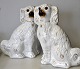 A pair of rare 
Staffordshire 
dogs in 
earthenware 
with glass 
eyes, 19th 
century. White 
with ...