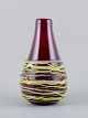 Murano, Italy, 
large 
mouth-blown 
spaghetti vase 
in burgundy art 
glass.
1970s.
In perfect ...