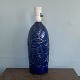 L. Hjorth lamp 
base of 
blue-glazed 
ceramic 
decorated with 
figures in 
relief. H. 28.5 
cm. H. Inc ...