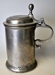 Pewter mug with 
lid and handle, 
18th century 
Germany. 
Stamped at the 
bottom. H.: 21 
cm. On lid ...