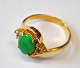 21 Carat gold 
ring with green 
jade and 6 
small 
brilliants, 
20th century. 
Indistinctly 
stamped. ...