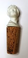 Wine cork in 
biscuit in the 
shape of a 
woman's bust 
with a cork 
stopper. 
Probably from 
Royal ...