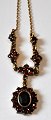Gilt sterling 
necklace with 
garnets, 20th 
century. 
Stamped: Gifa. 
L.: 46 cm.