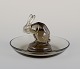 René Lalique, 
France. Early 
Art Deco pin 
dish with a 
rabbit in 
smoked art 
glass.
Approximately 
...
