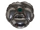 Georg Jensen 
sterling 
silver, brooch 
with green 
stone.
Design number 
113.
This was ...