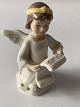Porcelain 
figurine from 
Royal 
Copenhagen, 
angel with 
music paper. 
The Christmas 
figure is from 
...