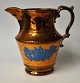 English luster 
jug, 19th 
century. Side 
blue decorated 
relief with 
peacock and 
flowers. H.: 
16.5 ...