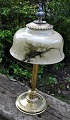 Danish table 
lamp in brass, 
approx. 1920. 
Stem and foot 
with 
decorations. 
Screen in 
painted ...