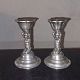 Pair of pewter 
candlesticks. 
Young naked 
woman on hwr 
knees holding 
the light head. 
Appears in ...