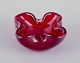 Murano, Italy. 
Art glass bowl 
in deep red 
glass with air 
bubbles inside. 
...