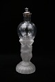 Decorative, old 
mouth-blown 
glass decanter 
with a motif of 
a child 
carrying a 
glass ball, as 
...