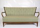 A sofa designed 
by Alfred 
Christiansen in 
green striped 
fabric, 
manufactured in 
walnut by ...