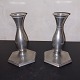 Pair of pewter 
candlesticks 
with 
baluster-shaped 
pipe and 
angular foot. 
Factory mark on 
the ...