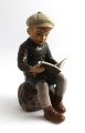 Dahl Jensen. 
Porcelain 
figure. Reading 
boy. Model 
1096. Height 15 
cm. (1 quality)