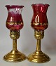 A pair of 
hurricanes in 
brass with red 
glass, approx. 
1900. Probably 
Turkey. Clear 
glass with ...